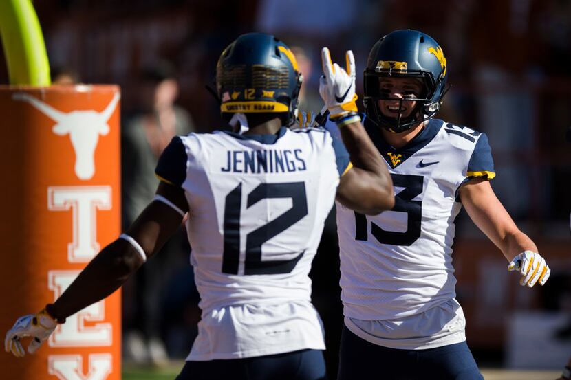 West Virginia Mountaineers wide receiver Gary Jennings Jr. (12) and wide receiver David...