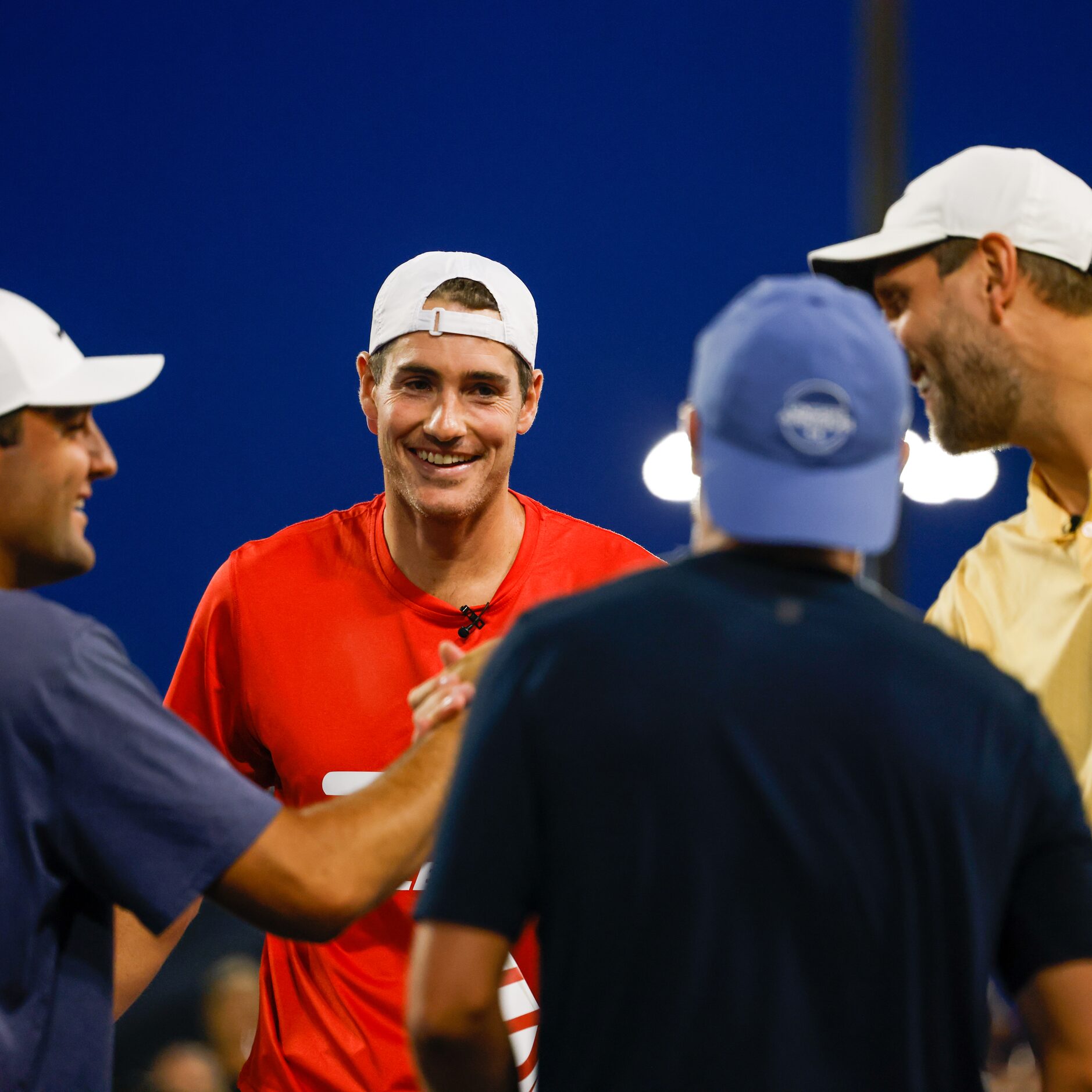 Scottie Scheffler (left to right), John Isner,  Jordan Spieth and Dirk Nowitzki shake hands...