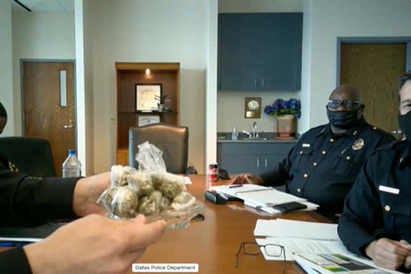 Dallas Police Chief Eddie Garcia holds up a small amount of marijuana during a city public...