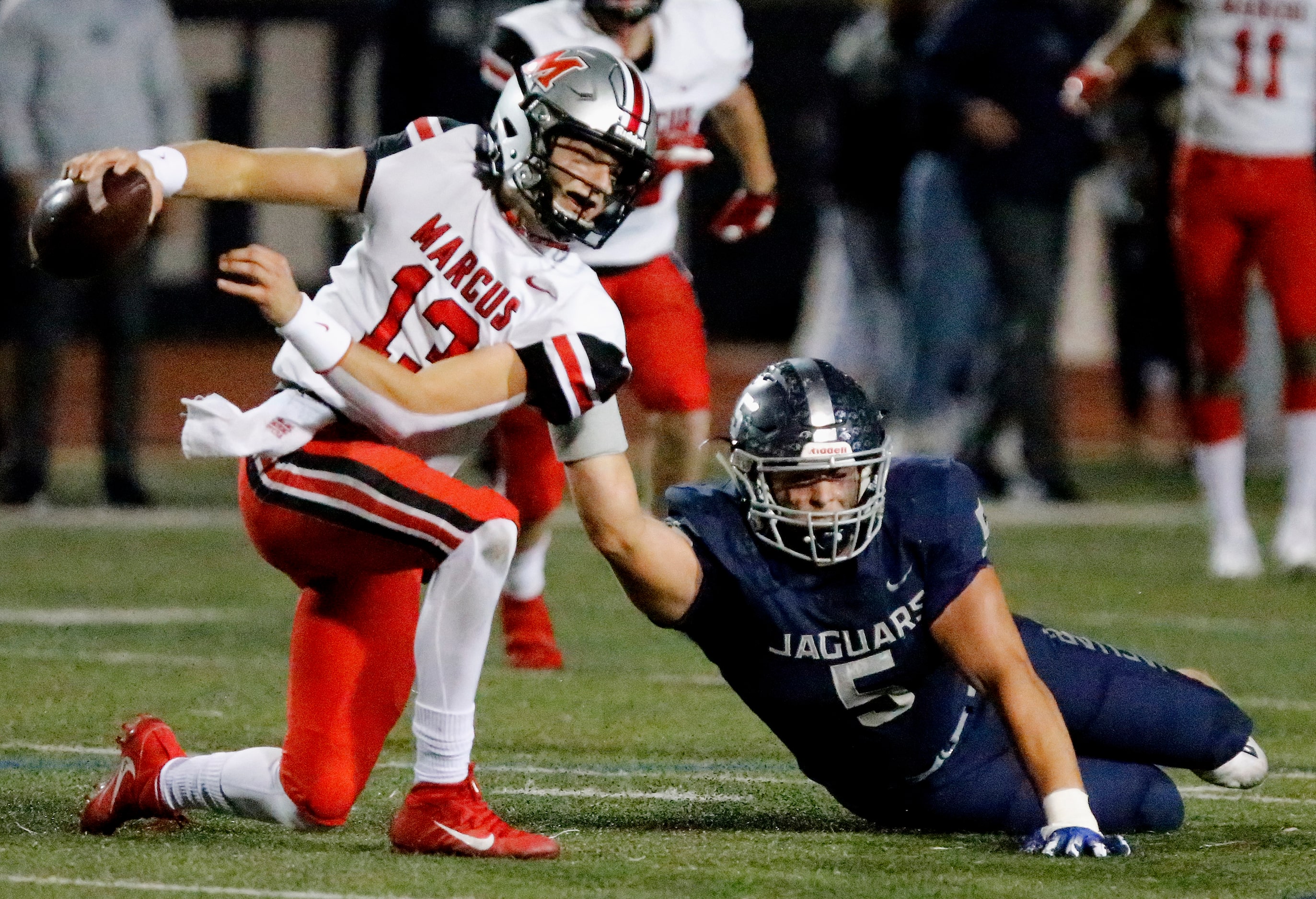 Flower Mound High School defensive end Stone Eby (5) brings down Flower Mound Marcus...