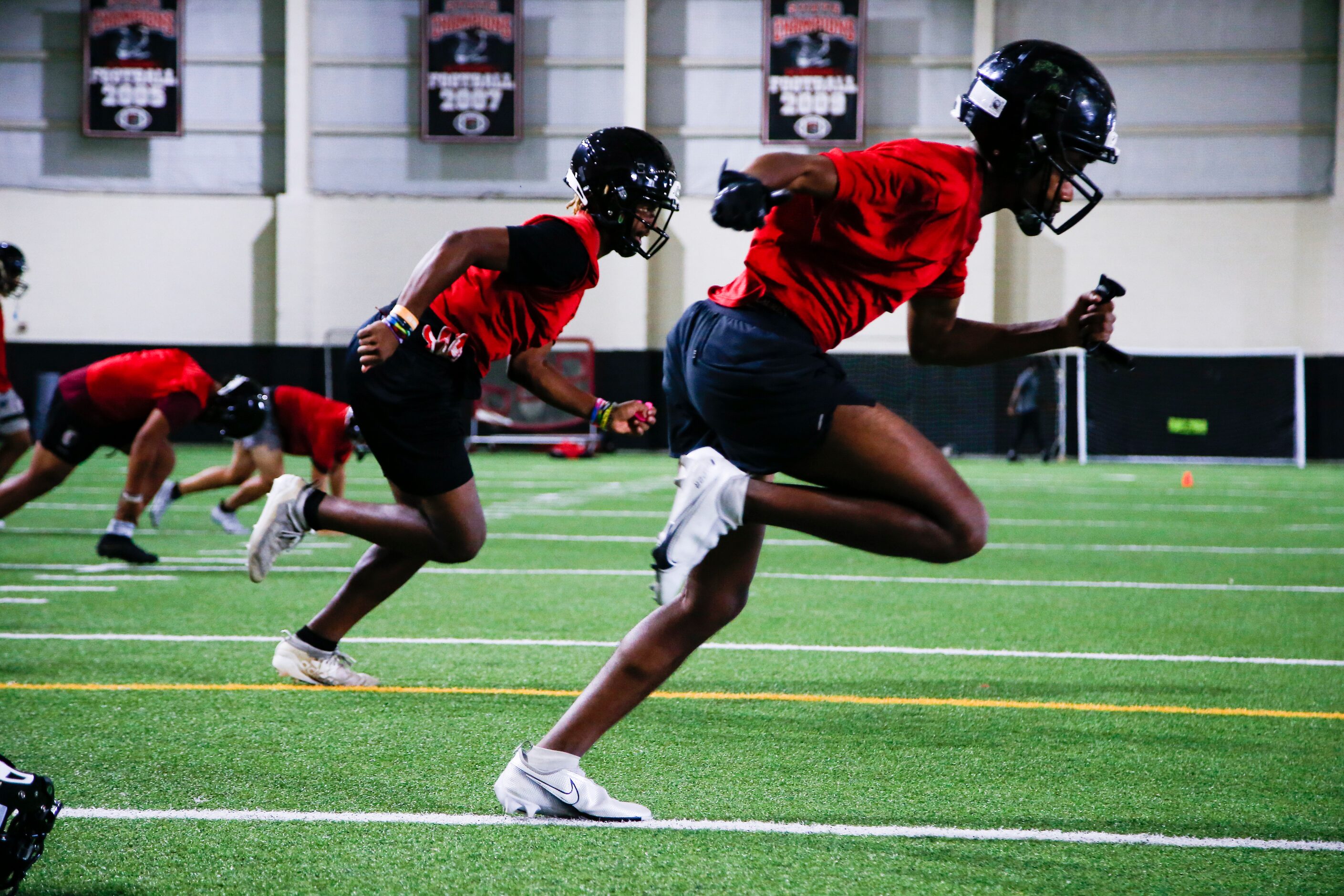 Euless Trinity’s varsity football team runs drills during a practice at Euless Trinity High...