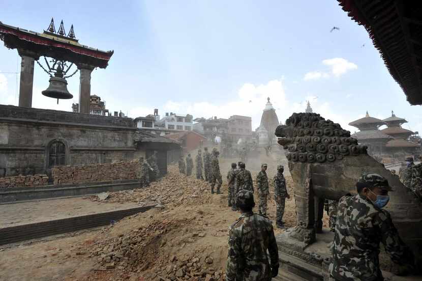 
Nepali soldiers line up to clear rubble of temples following the earthquake at Patan Durbar...