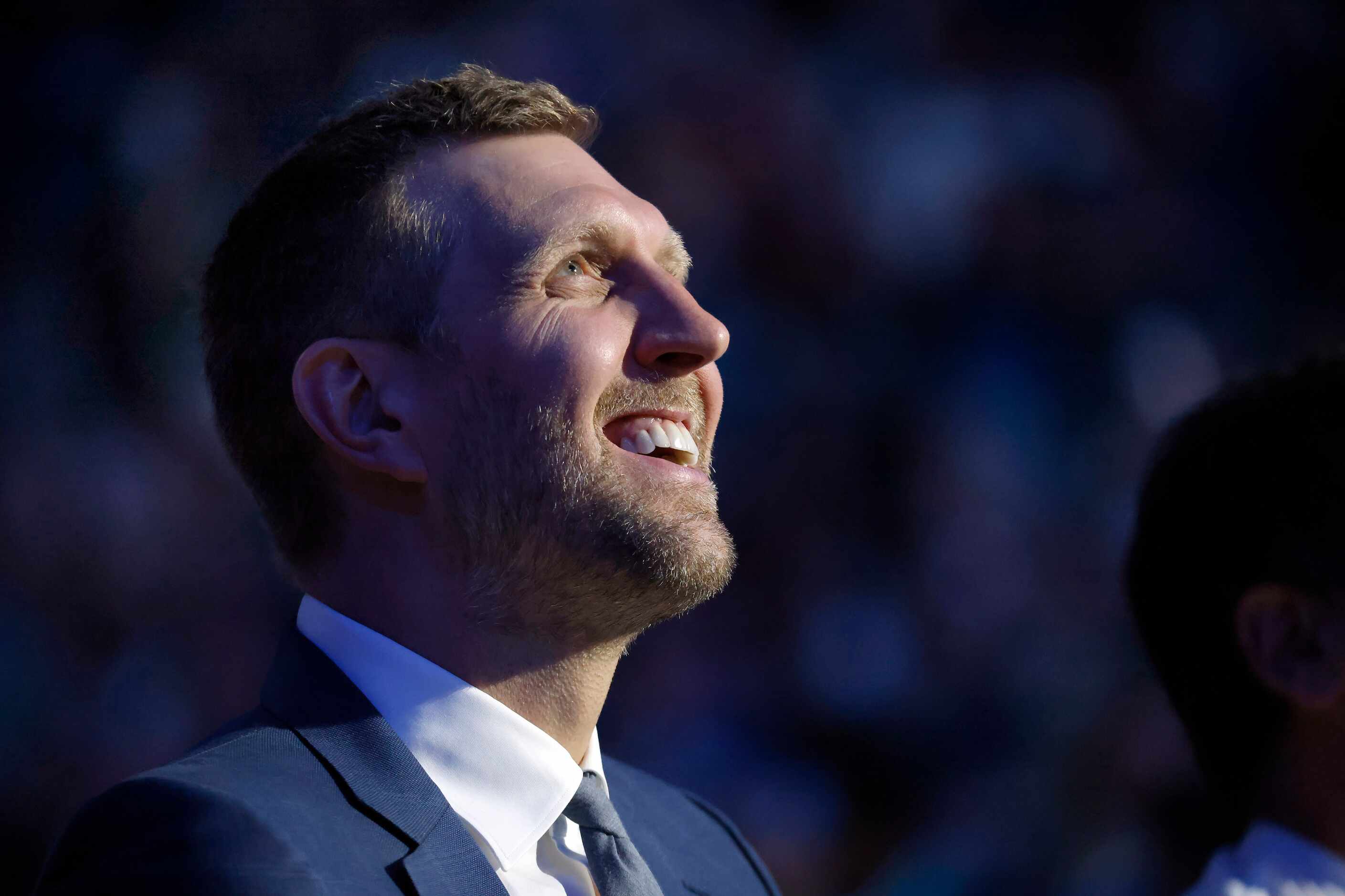 Former Dallas Mavericks All-Star Dirk Nowitzki flakes a smile as he watches a tribute video...