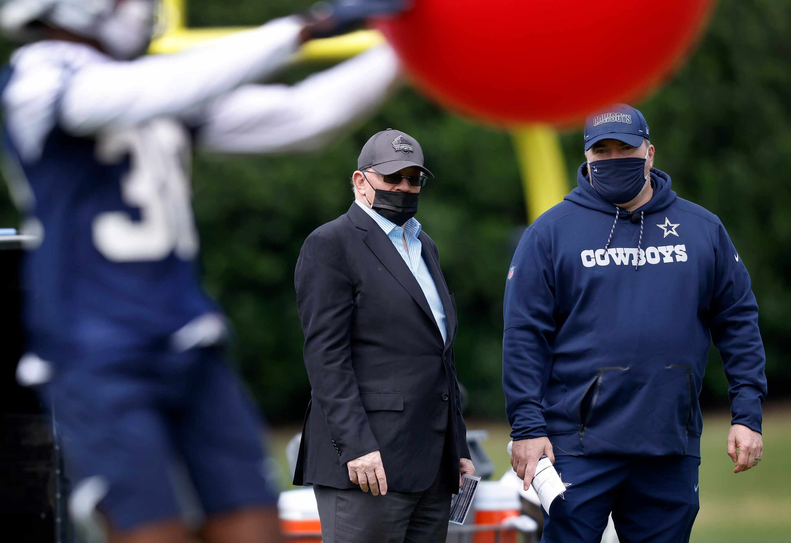 Dallas Cowboys owner Jerry Jones (left) and head coach Mike McCarthy visit on the sideline...