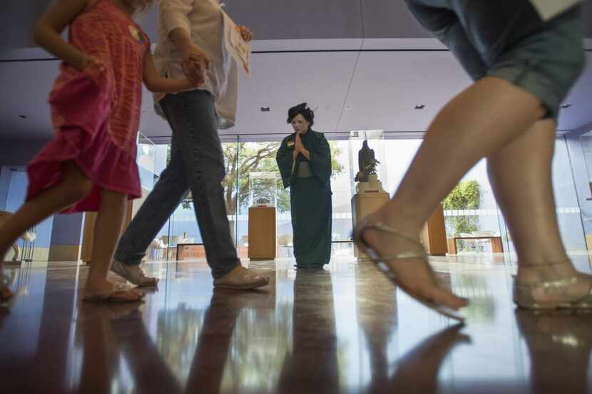 A staff member dressed a geisha greets visitors to the Fort Worth Museum of Science and...