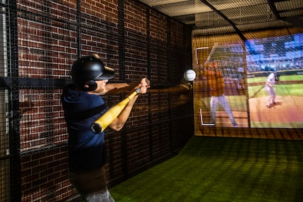 Batbox customers step into an indoor batting cage and swing at a ball. Laser technology...