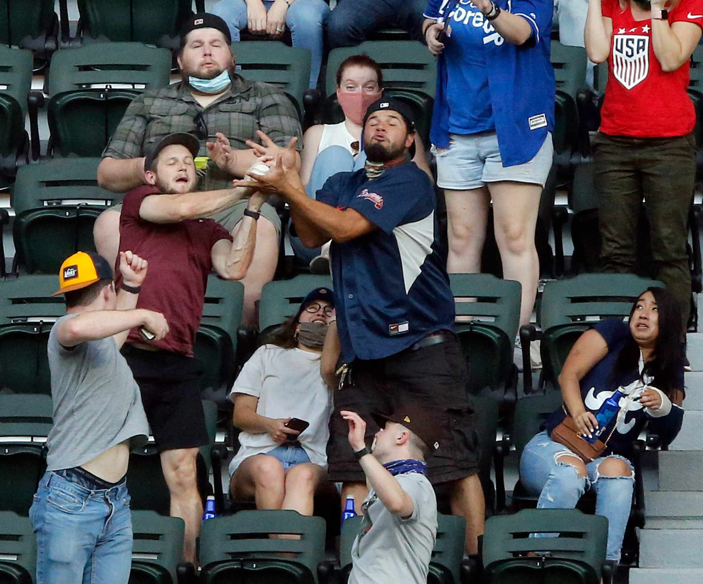Fans battle for a home run ball hit by Los Angeles Dodgers Corey Seager during the third...