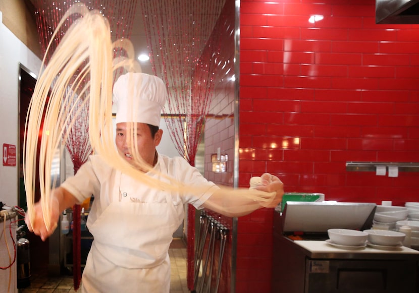 Zhang Xue "Charlie" Liang hand pulls dough to make noodles at Imperial Cuisine. (Rose...