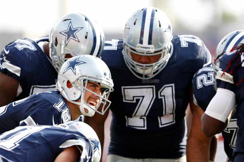 Dallas Cowboys quarterback Matt Cassel (16) calls the next play in the huddle during the...