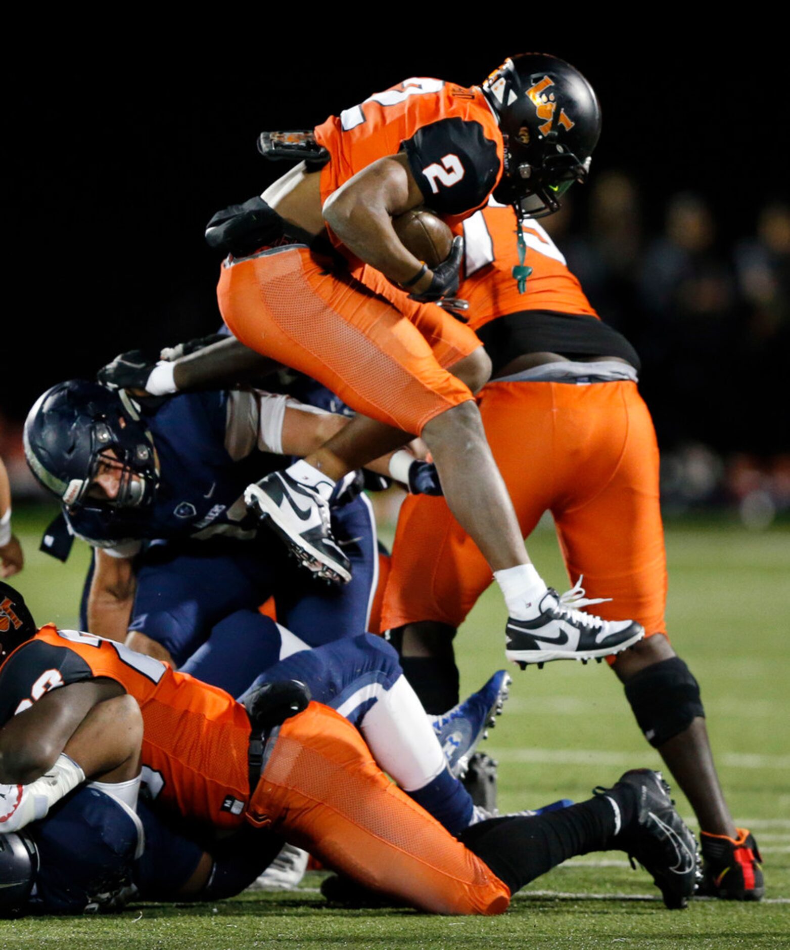 Lancaster running back Tre Bradford (2) hurdles a teammate in the first quarter against...