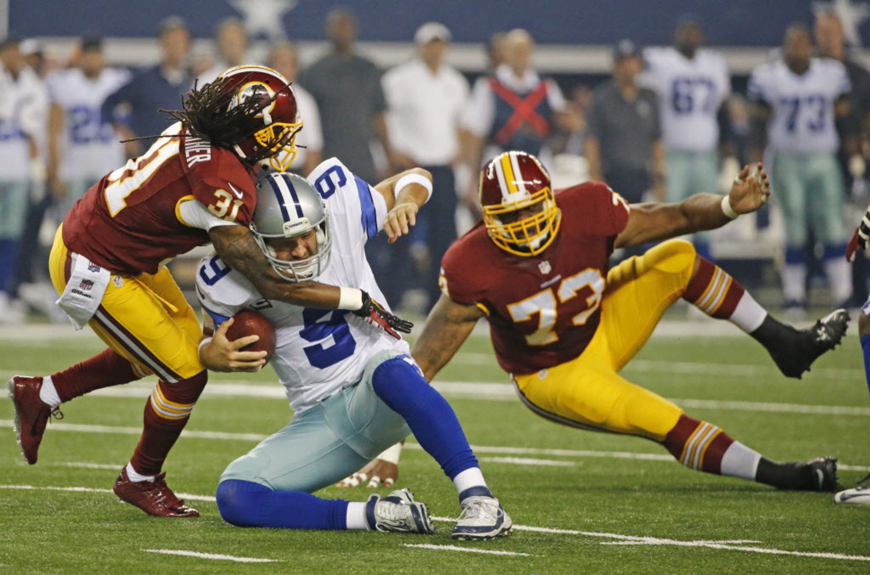 Dallas Cowboys quarterback Tony Romo (9) is sacked by Washington Redskins strong safety...