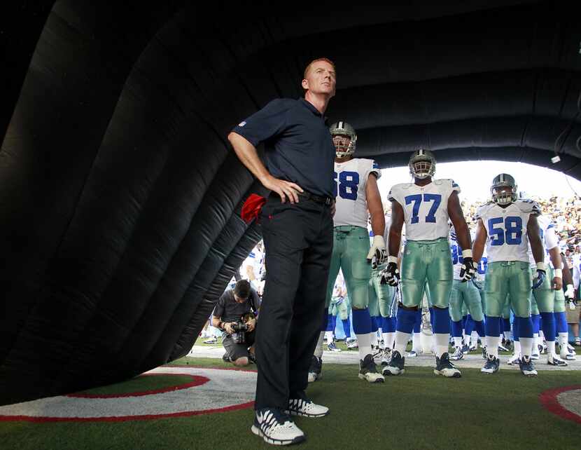 Cowboys head coach Jason Garrett waits with his players before being introduced as a team in...