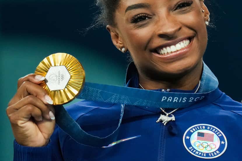 Gold medalist Simone Biles of the United States poses with her medal after winning the...