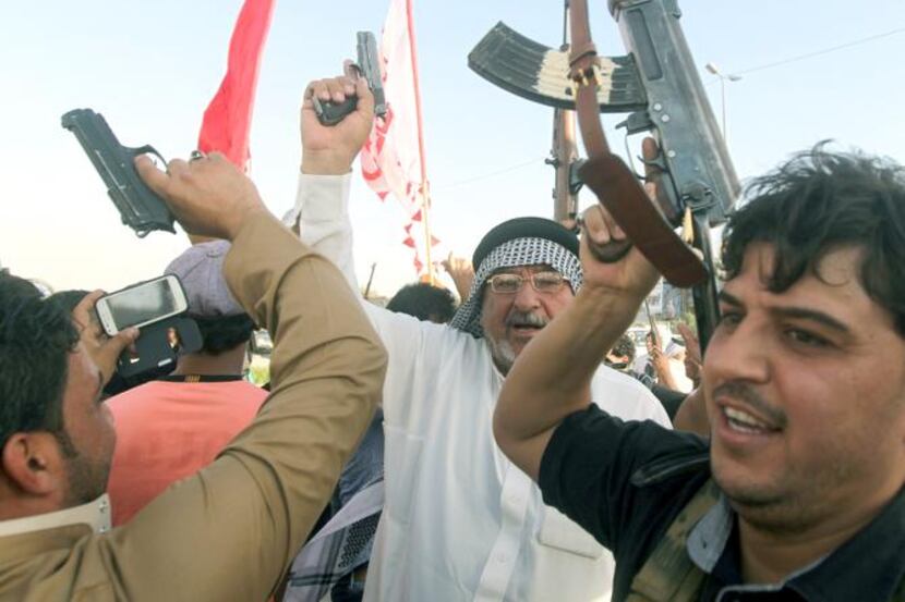 
Iraqi tribesmen carried weapons in Baghdad on Sunday as they volunteered to fight alongside...