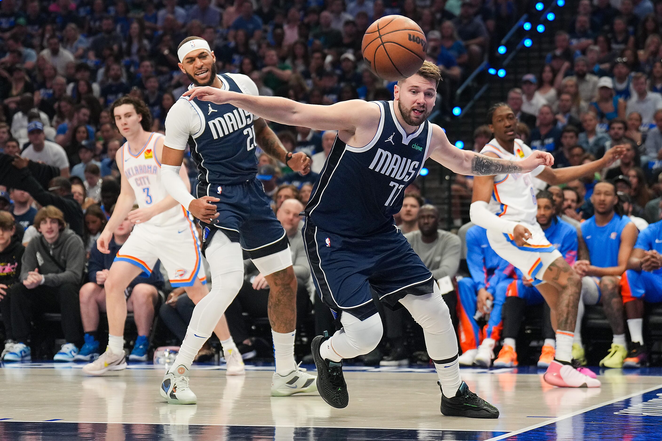 Dallas Mavericks guard Luka Doncic (77) chases a rebound during the first half in Game 3 of...