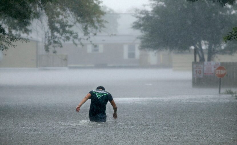 A man headed back into the flooded Pearland Acres Mobile Home Community to help rescue and...