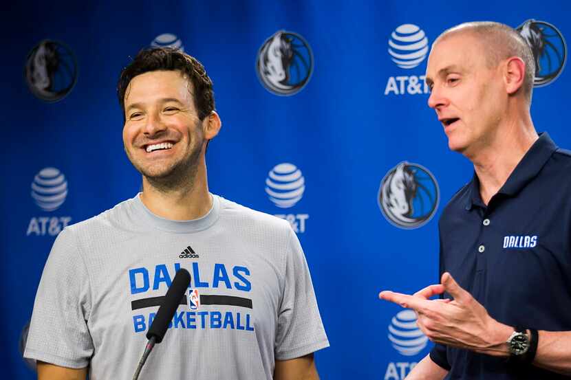 Tony Romo laughs while addressing the media with Dallas Mavericks head coach Rick Carlisle...