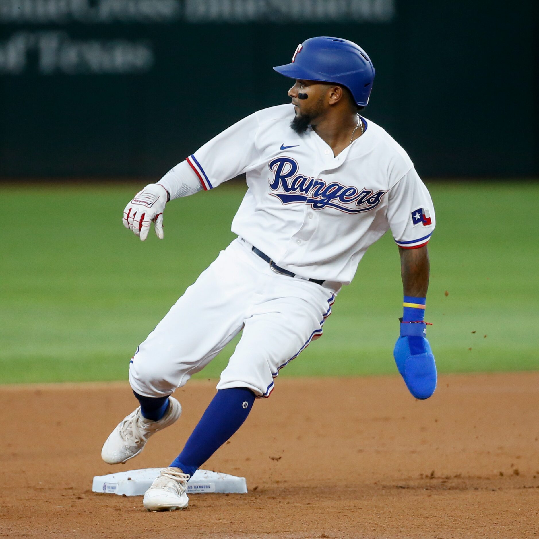 Texas Rangers second baseman Yonny Hernandez (65) watches the ball rounding second base...