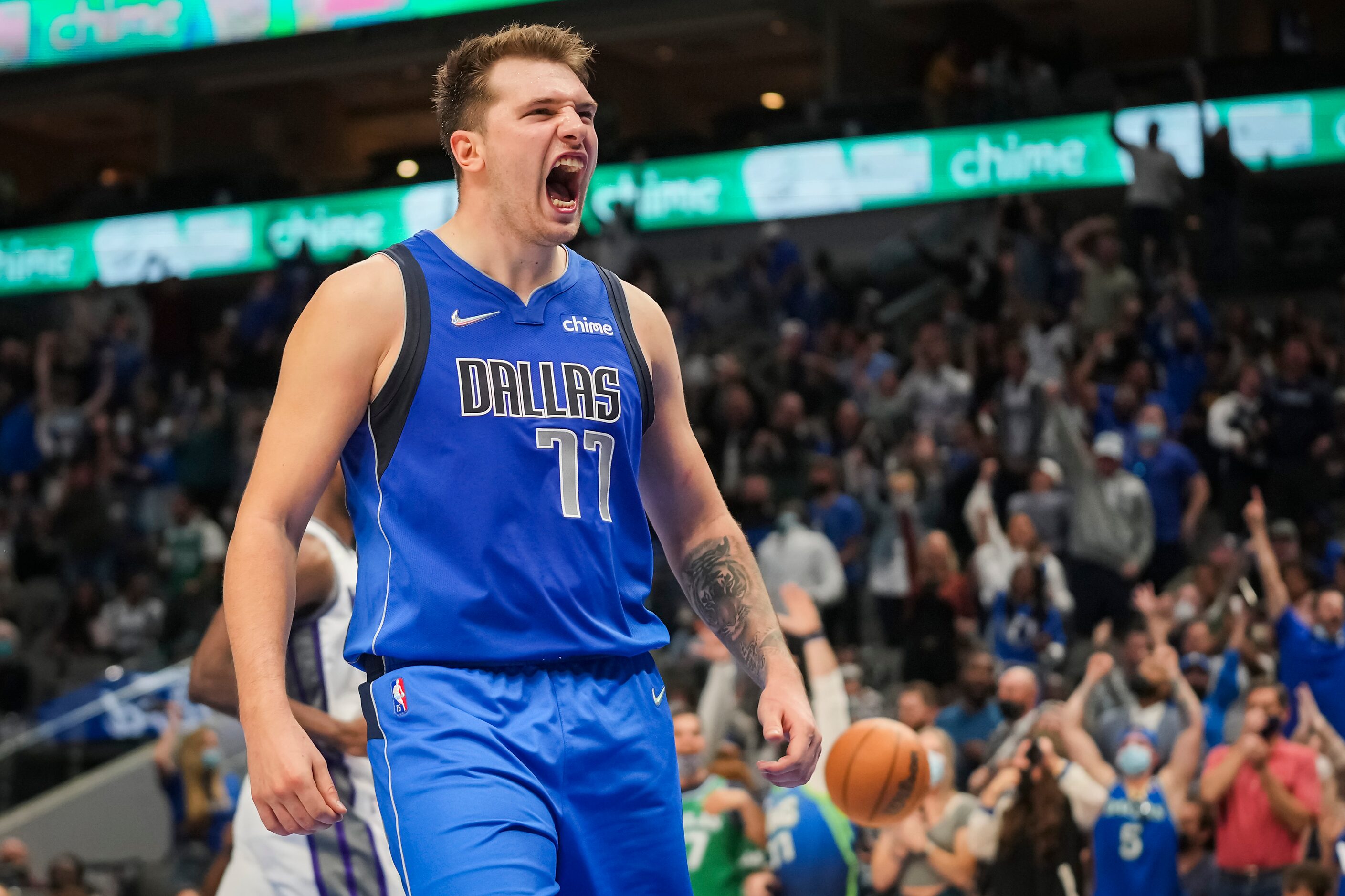 Dallas Mavericks guard Luka Doncic (77) celebrates after feeding forward Dorian Finney-Smith...