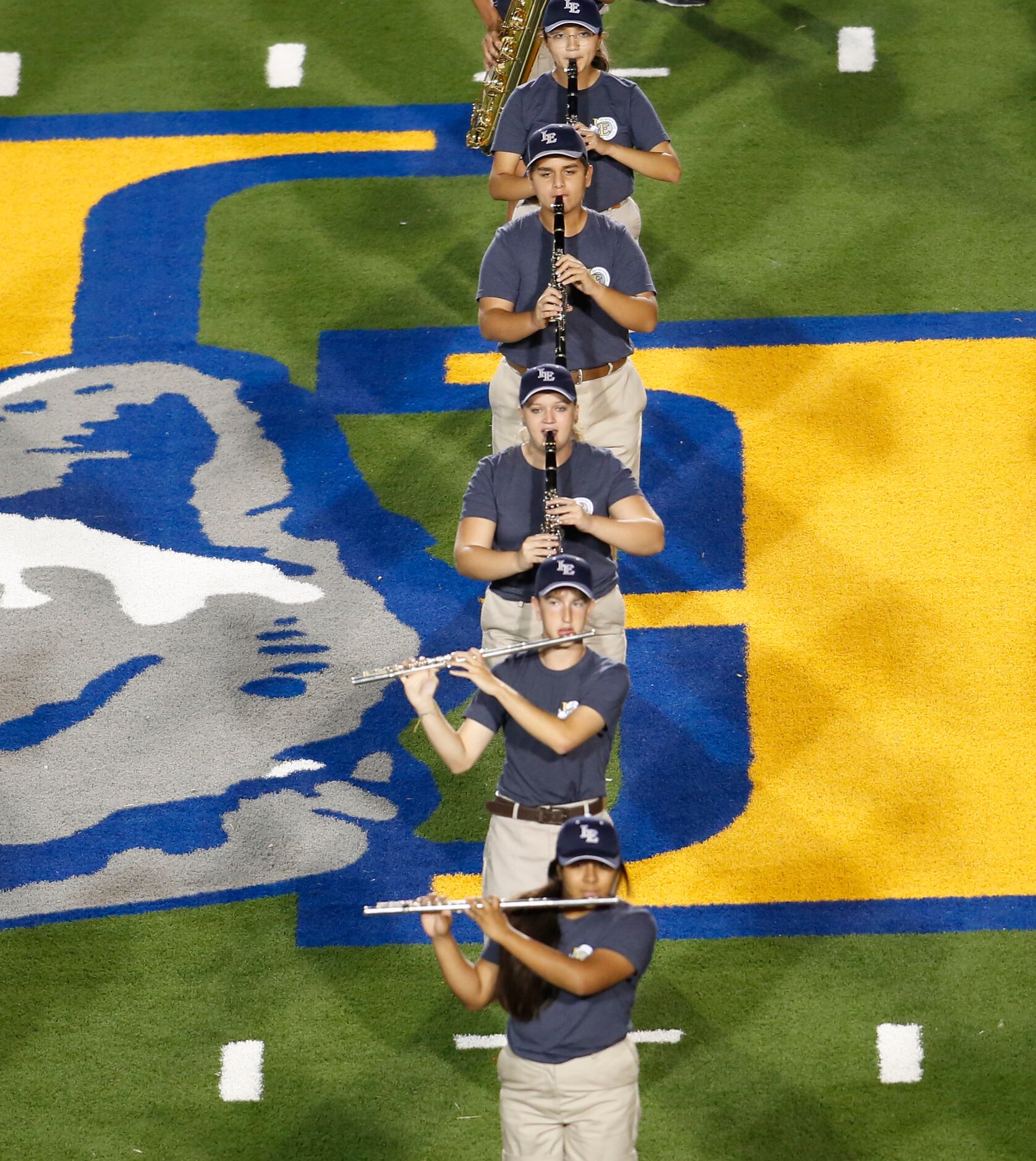 Members of the Little Elm marching band perform at mid field during halftime of the Plano...