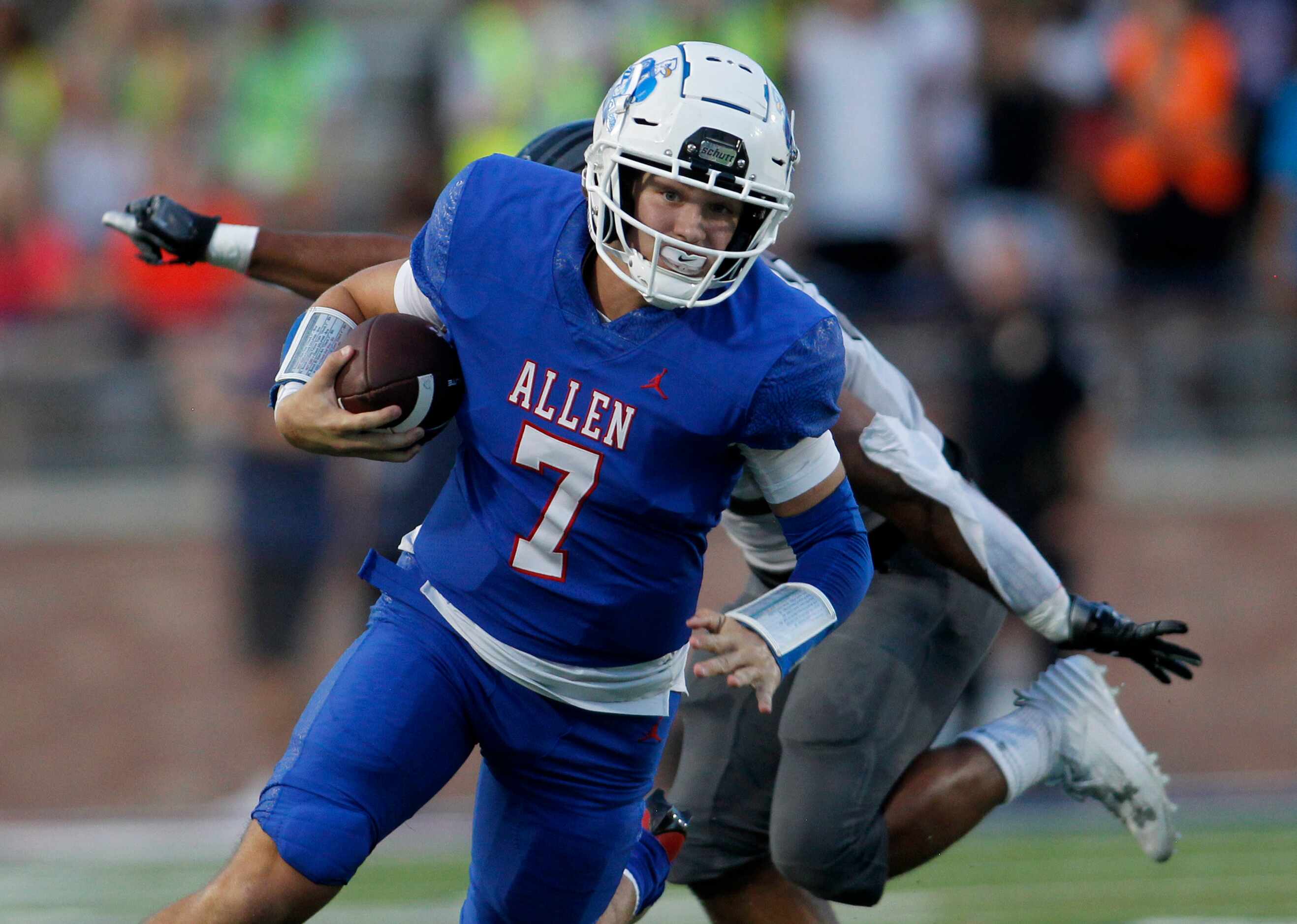 Allen quarterback Brady Bricker (7) rushes for a first down as he is being pursued...