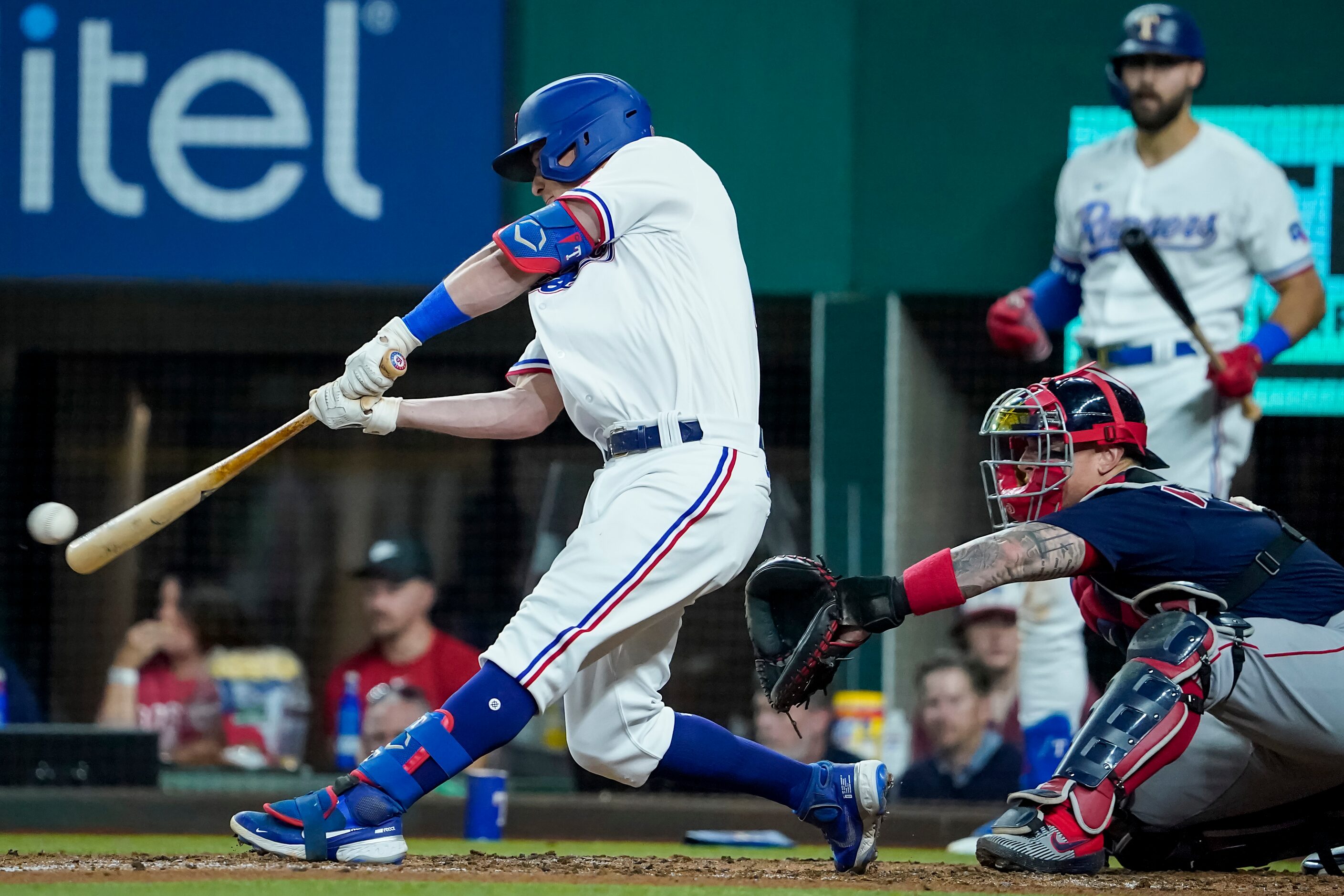 Texas Rangers second baseman Nick Solak drives in two runs with a single during the third...