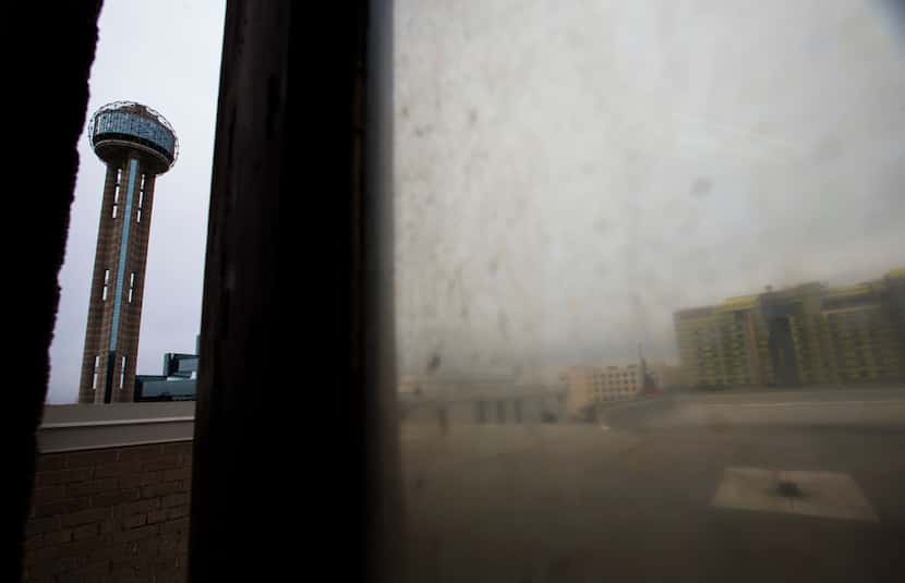 Reunion Tower is seen through a propped open fifth-floor roof access door at the 508 Young...
