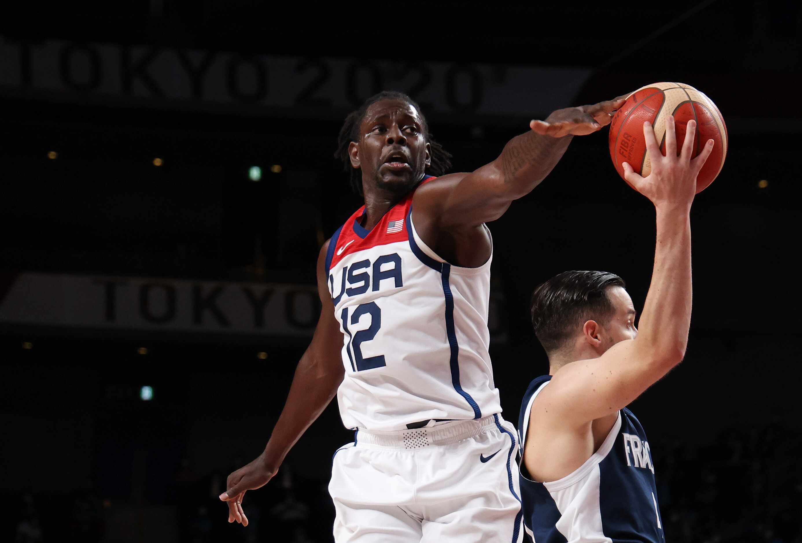 USA’s Jrue Holiday (12) swipes the ball away from France’s Thomas Heurtel (4) during the...