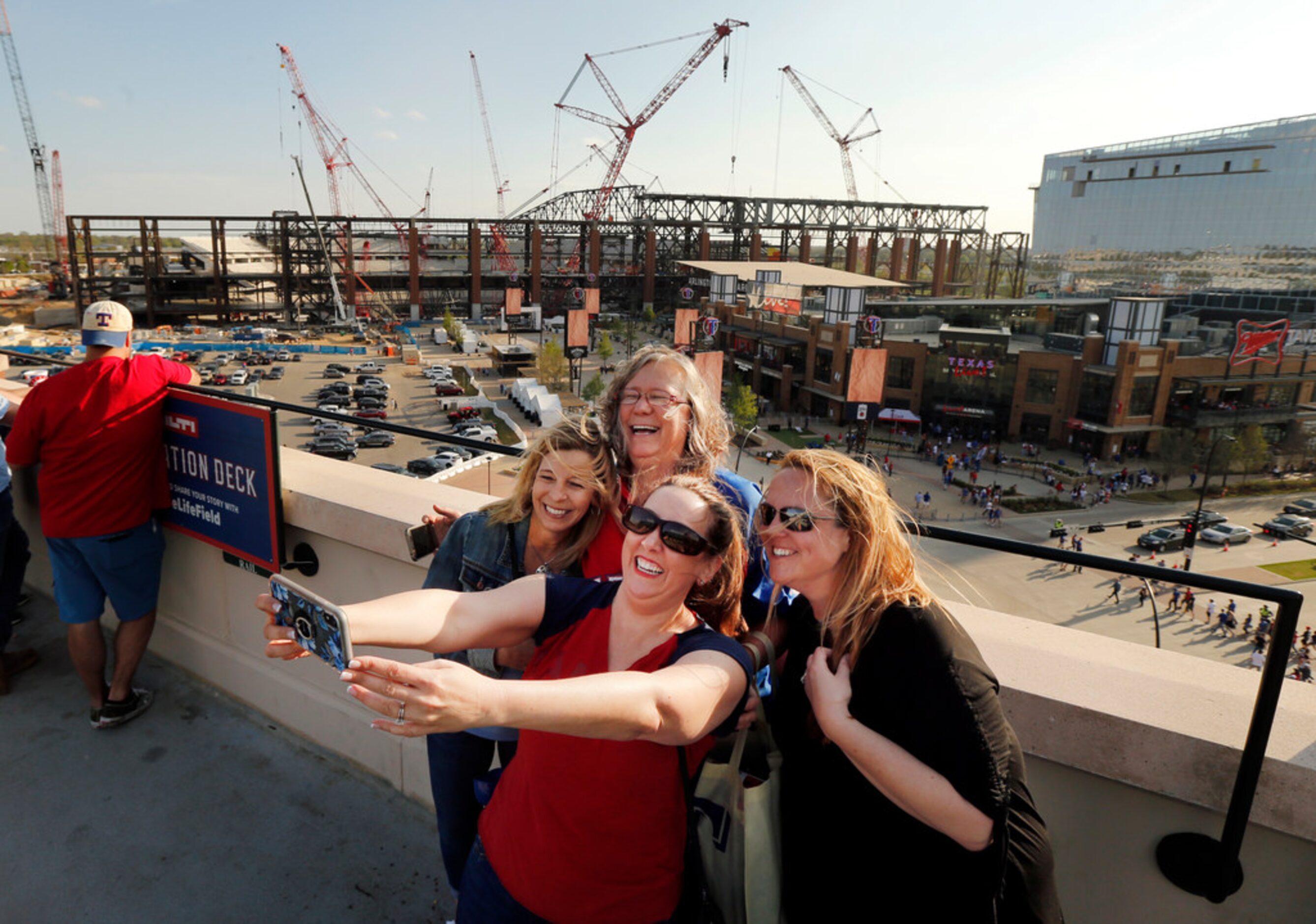 Texas Rangers fans (from left) Shannon Bennett of Grandview, Texas, Traci Jenkins of...