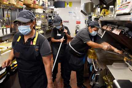 McDonald's employees Maria Soto (left) Lucila Padilla and Emma Gomez, work in the kitchen...