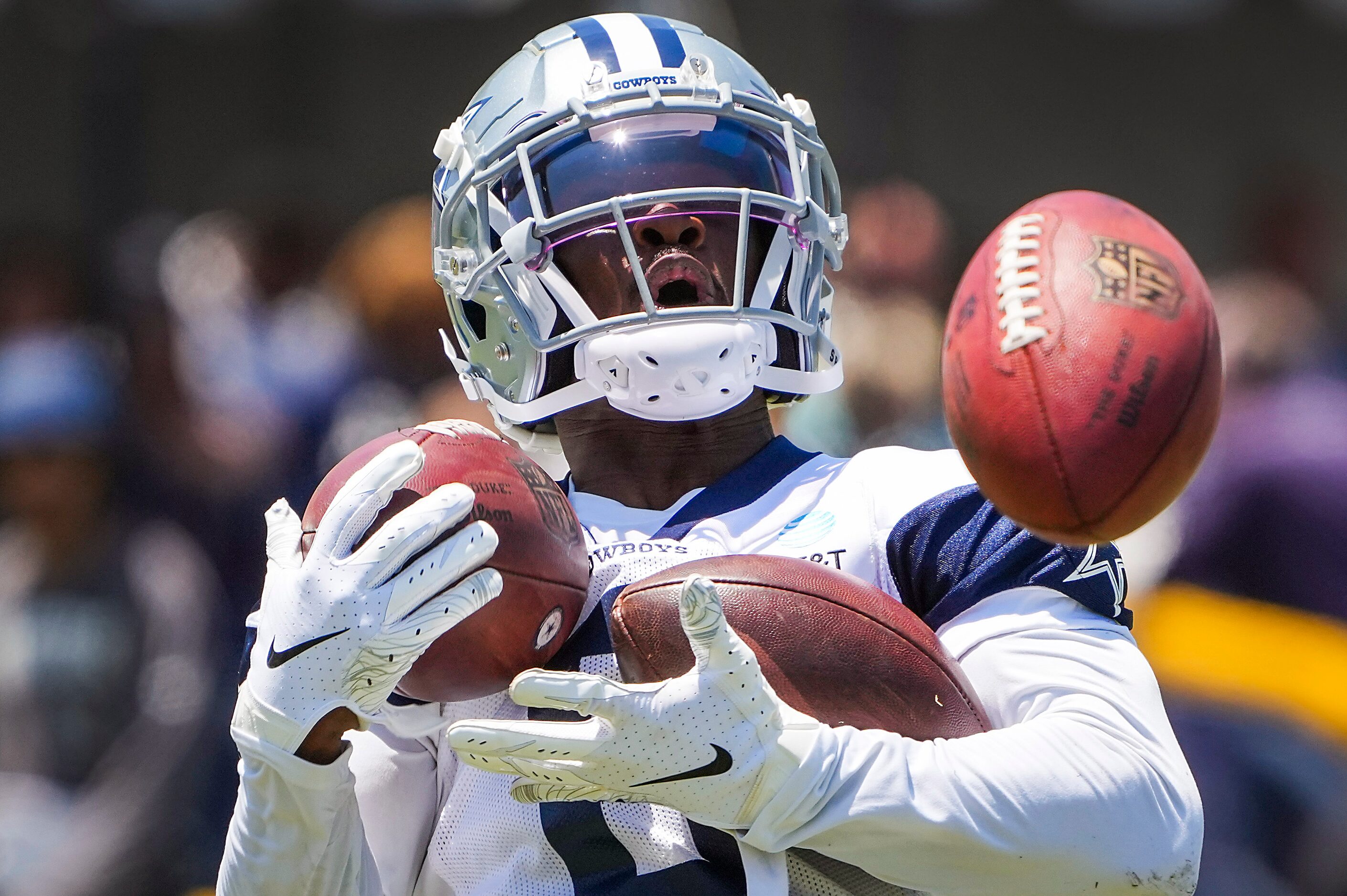 Dallas Cowboys wide receiver Johnnie Dixon tries to catch three footballs during a special...