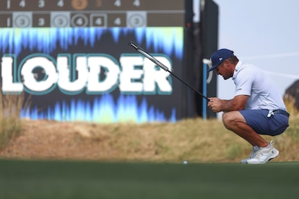 Bryson DeChambeau of the Crushers GC lines up his putt on the 17th green during the...