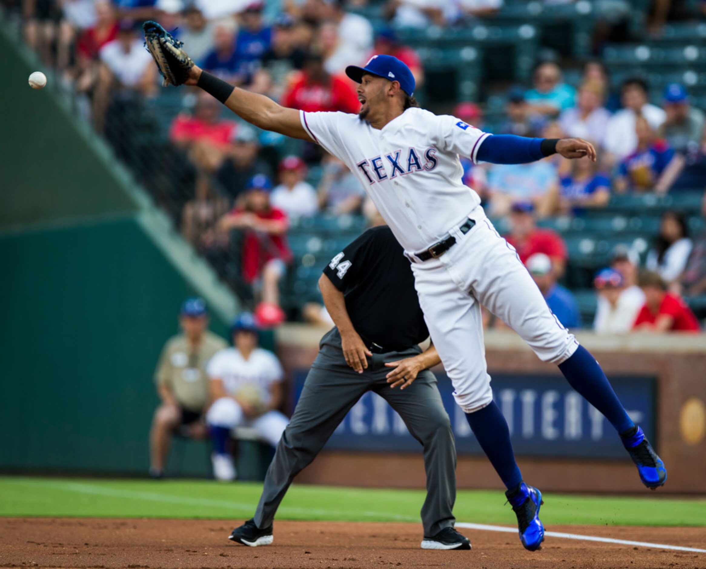 Texas Rangers first baseman Ronald Guzman (67) misses a throw to first as Oakland Athletics...