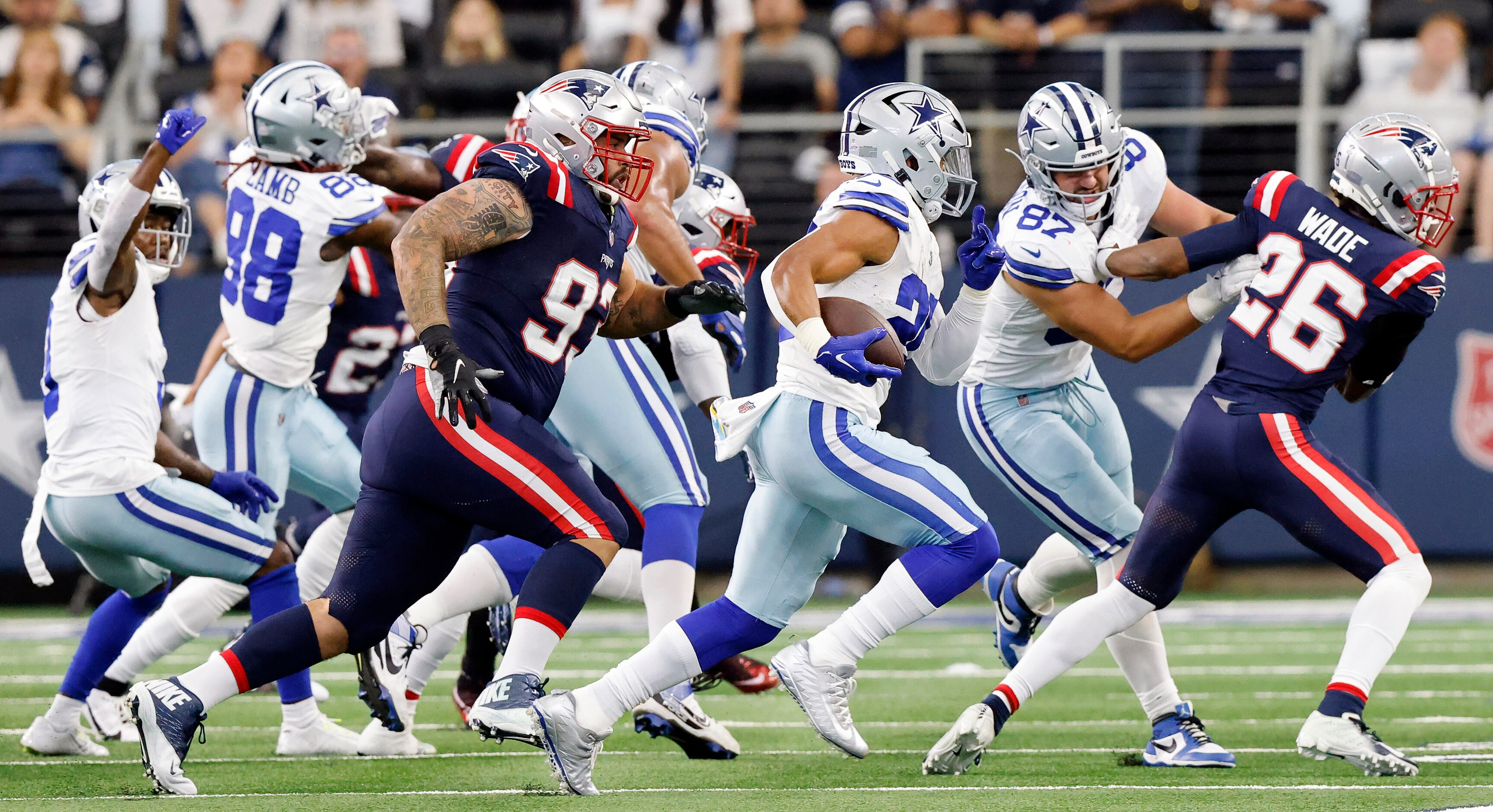 Dallas Cowboys running back Tony Pollard (20) carries the ball as he's pursued by New...