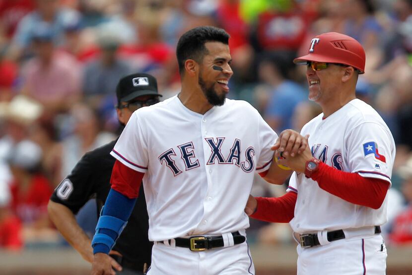 Texas Rangers' Robinson Chirinos reacts after hitting a one-run RBI single in the fifth...