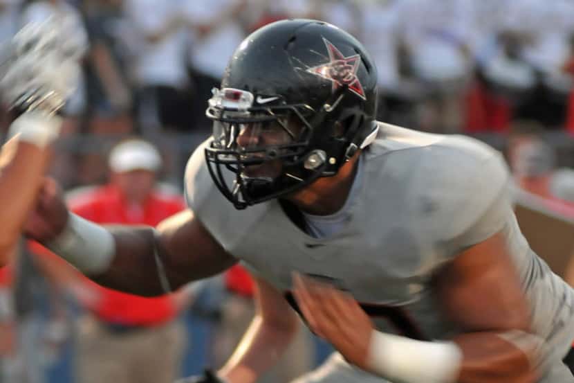 Coppell senior Solomon Thomas (90) rushes the line during a high school football game...