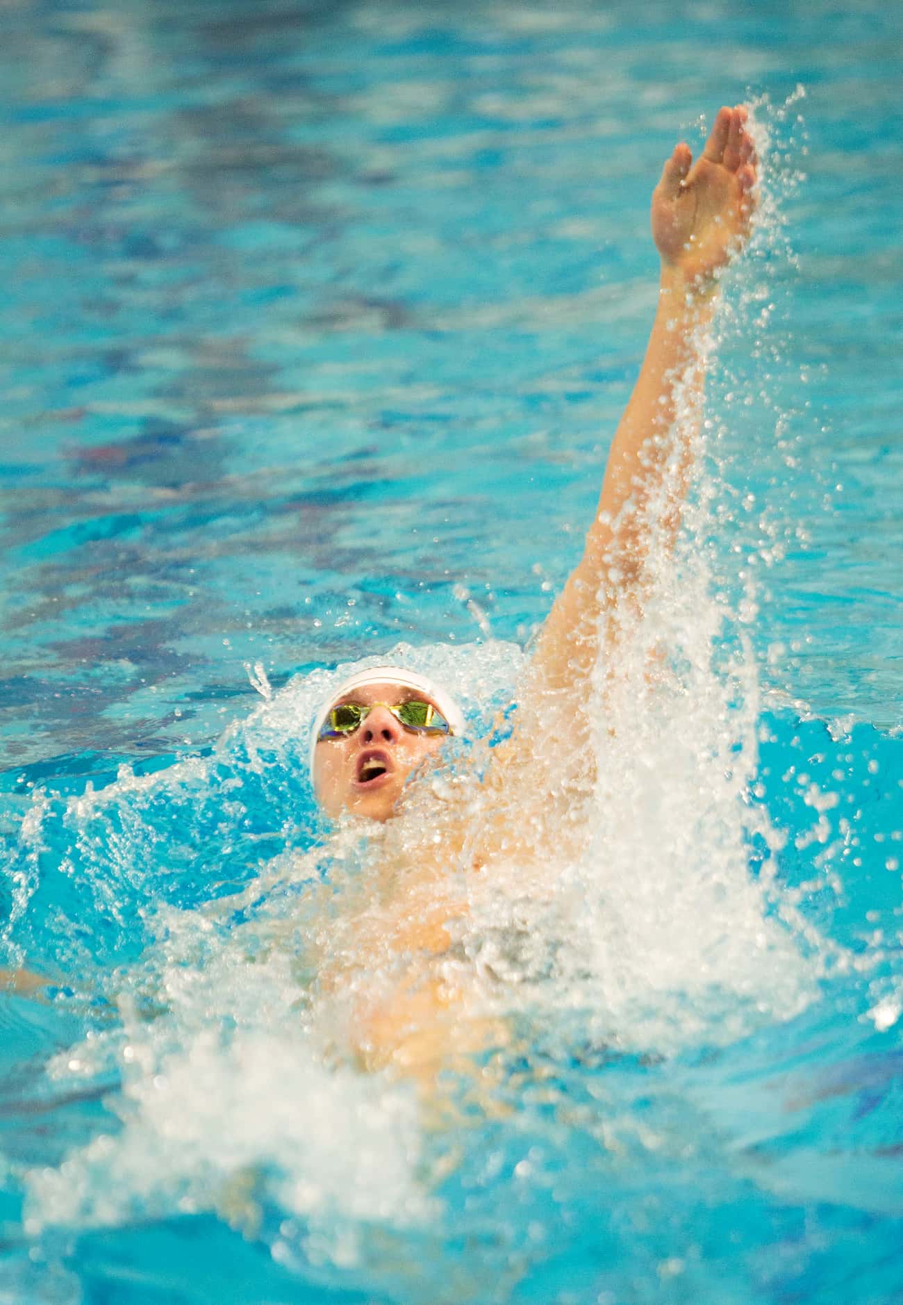 Keller’s Maximus Williamson competes in the boys 100-yard backstroke race during the 6A...