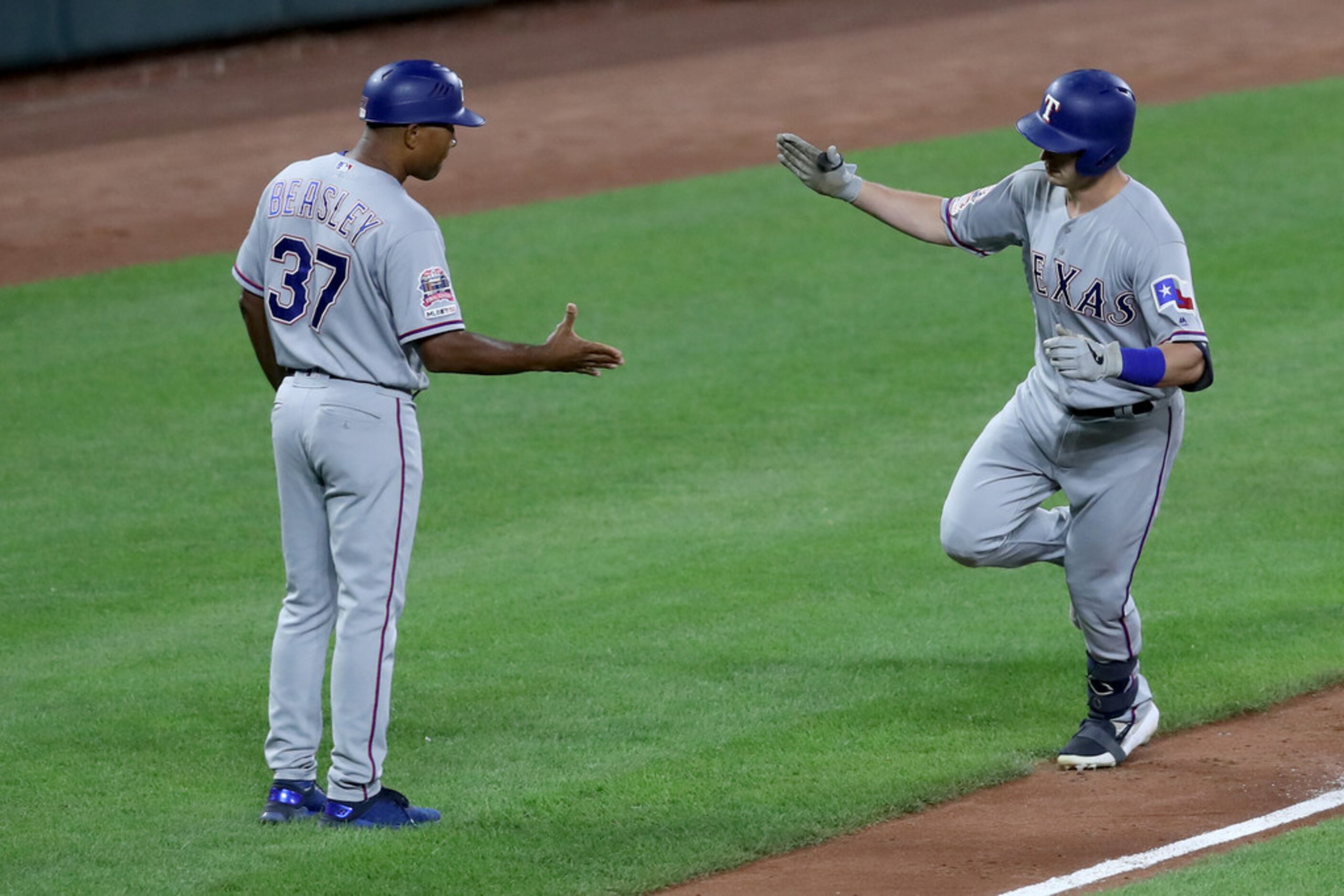 BALTIMORE, MARYLAND - SEPTEMBER 05: Nick Solak #15 of the Texas Rangers is congratulated by...