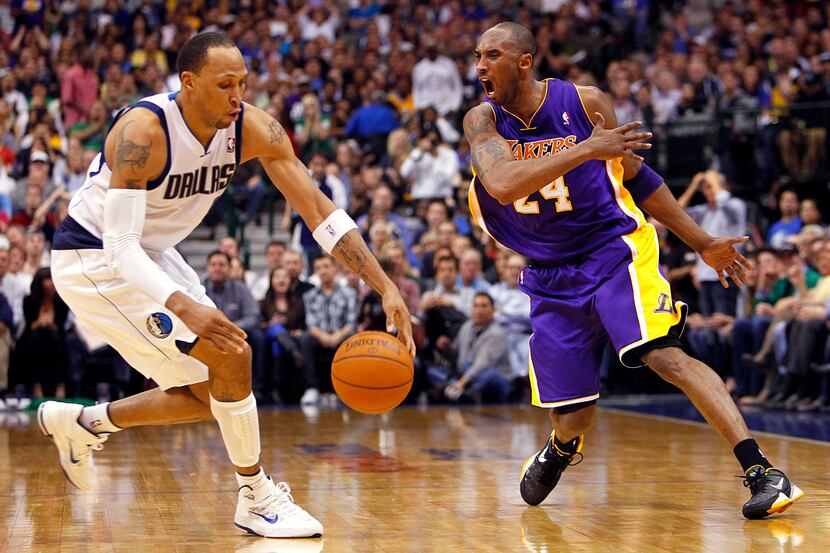 Lakers star Kobe Bryant reacts angrily as Dallas' Shawn Marion steals the ball from him in...
