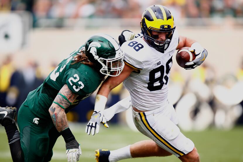 EAST LANSING, MI - OCTOBER 29: Jake Butt #88 of the Michigan Wolverines looks to get around...