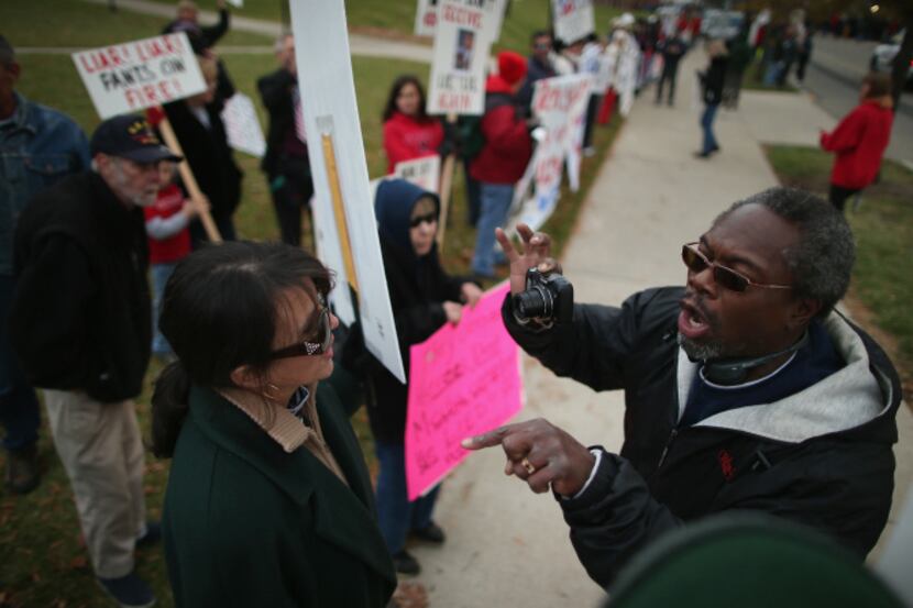 Lunnie Harris shouted, "Four more years! Get used to it!" to demonstrators outside a rally...