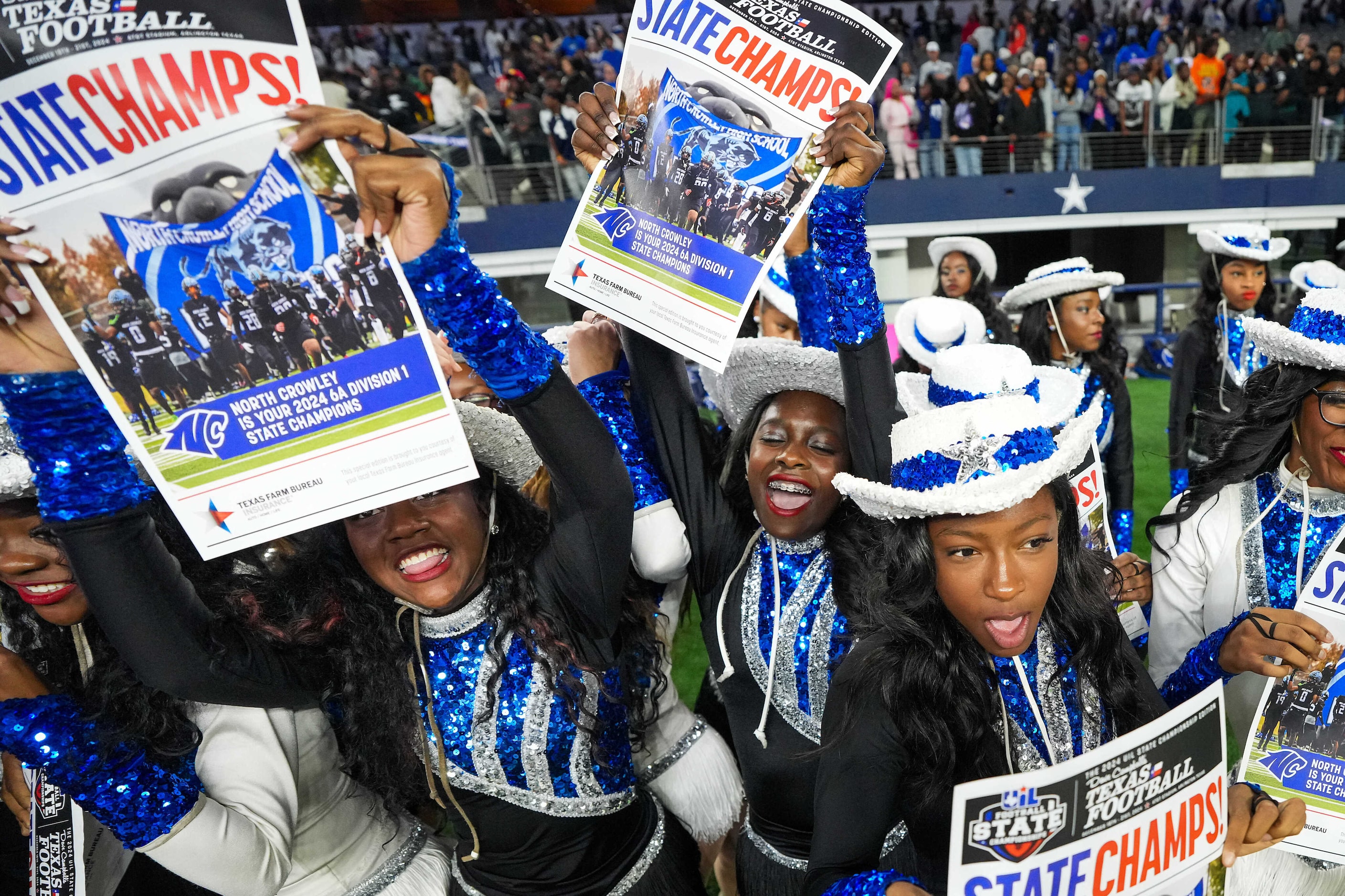 Members of the North Crowley drill team celebrate after a victory over Austin Westlake in...