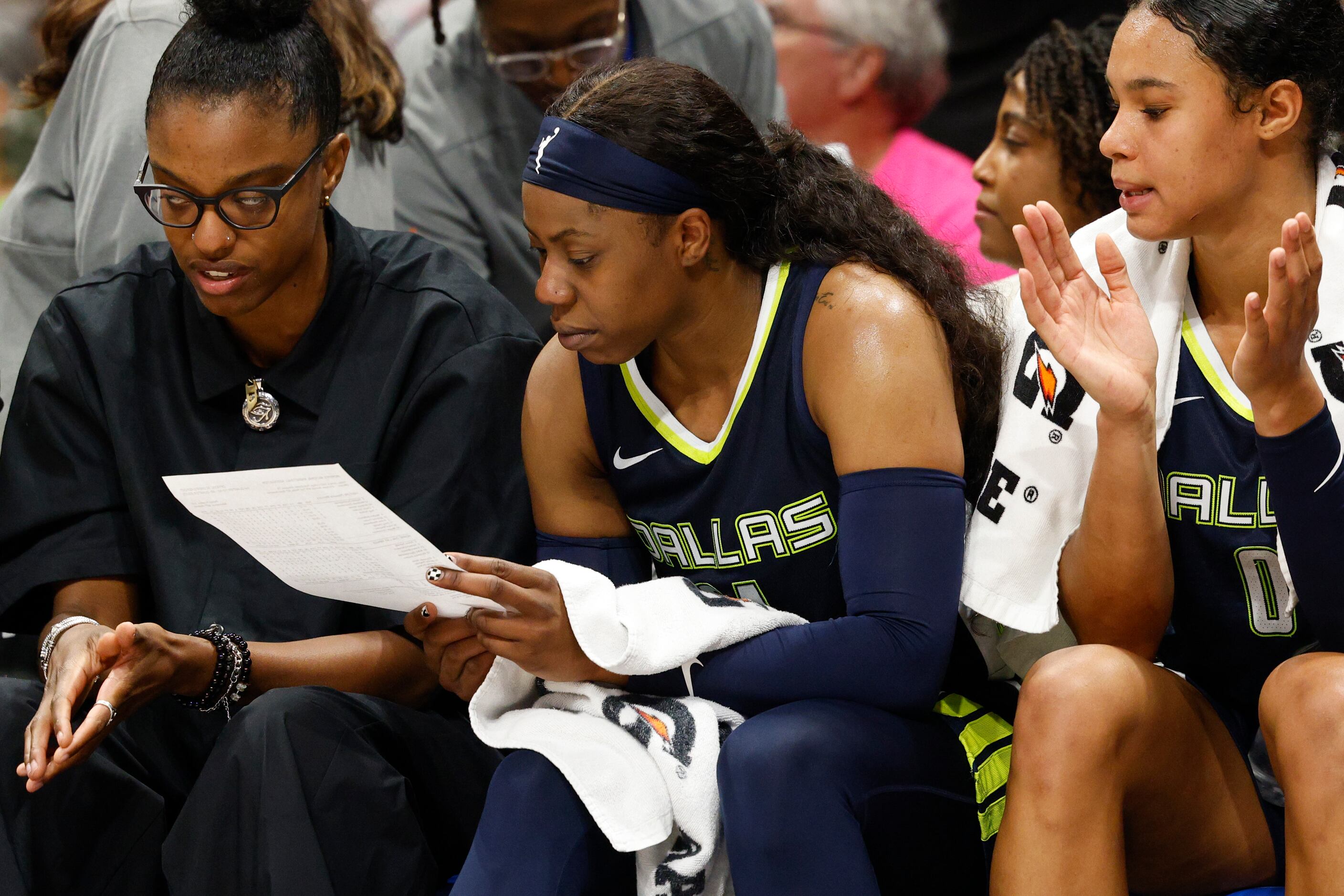 Dallas Wings guard Arike Ogunbowale (24) checks her stats after exiting the game during the...