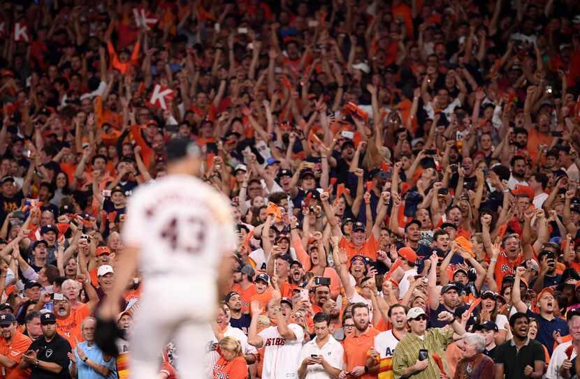 Houston Astros fans cheer as their team closed in on the American League pennant in the...