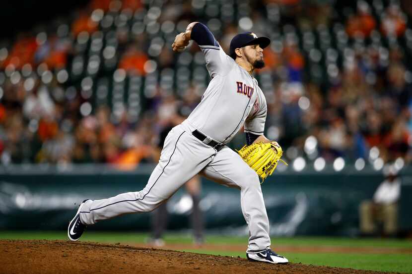 Houston Astros relief pitcher Roberto Osuna throws to the Baltimore Orioles in the ninth...