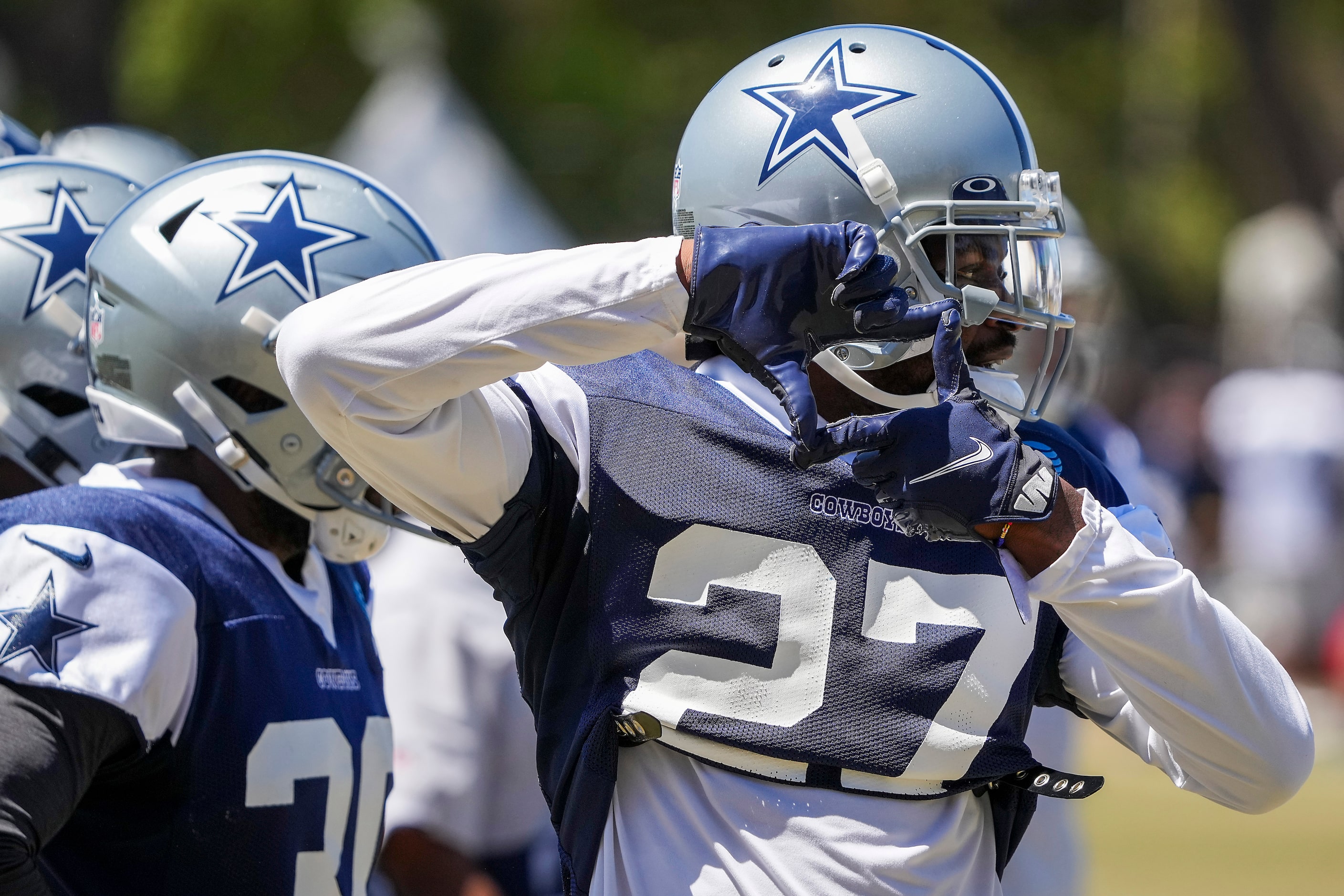 Dallas Cowboys cornerback Trevon Diggs (27) signals to teammates during a practice at...