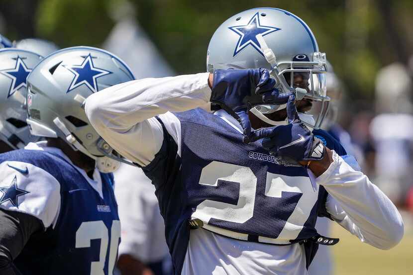 Dallas Cowboys cornerback Trevon Diggs (27) signals to teammates during a practice at...