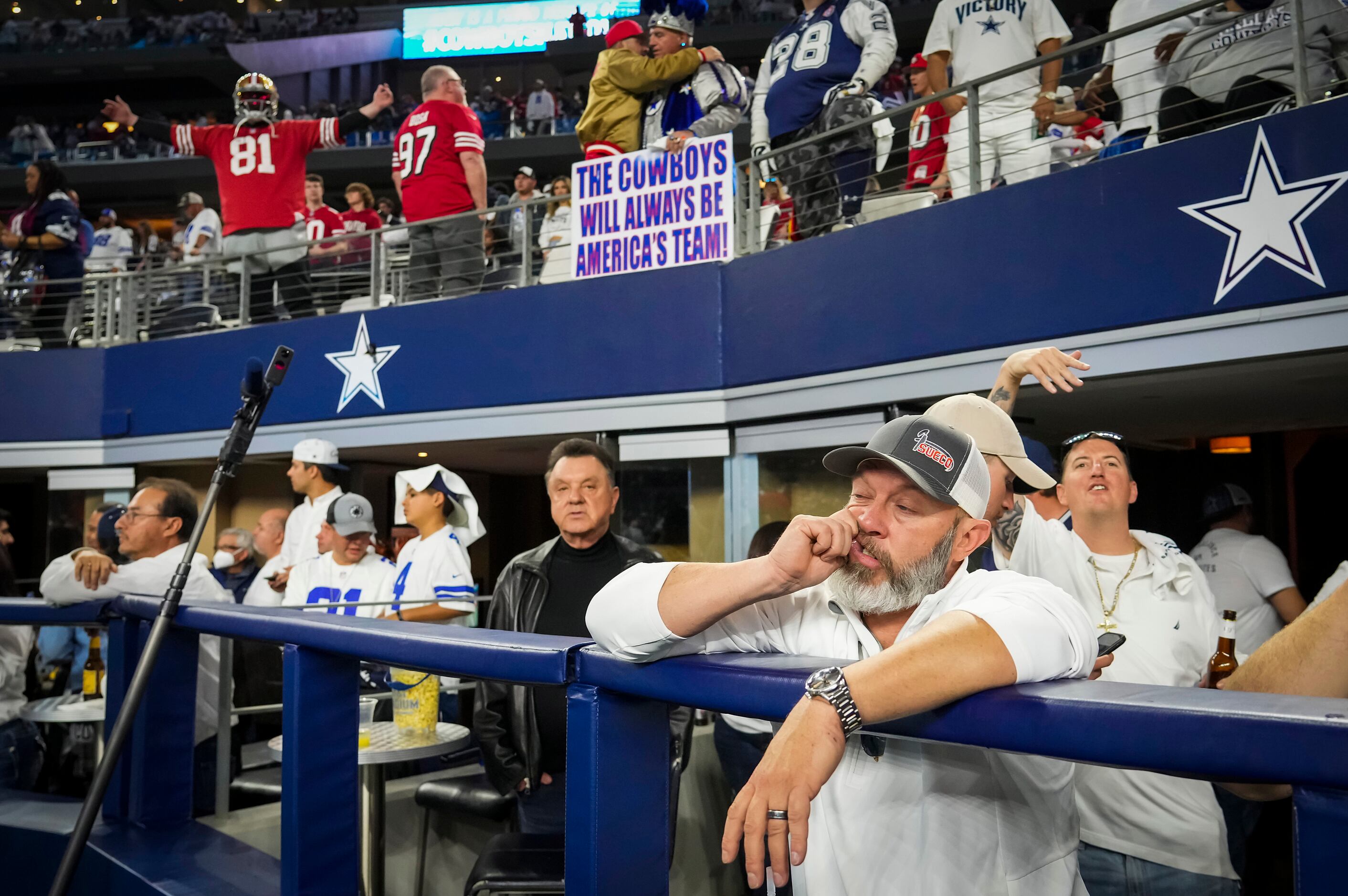 Dallas Cowboys fans react as players leave the field following a loss to the San Francisco...