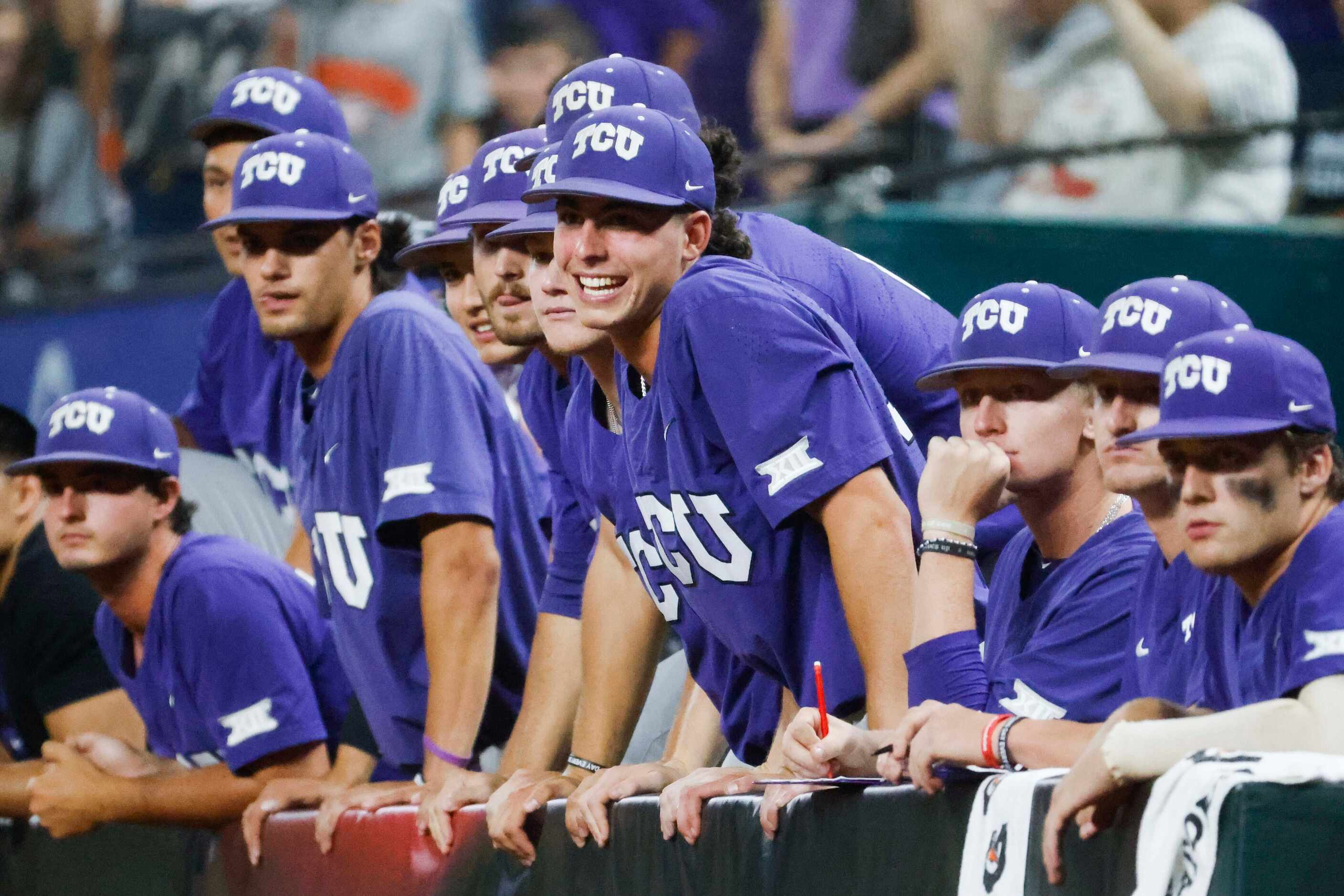 TCU players cheerfully wait in the dugout ahead of winning the Big 12 baseball championship...