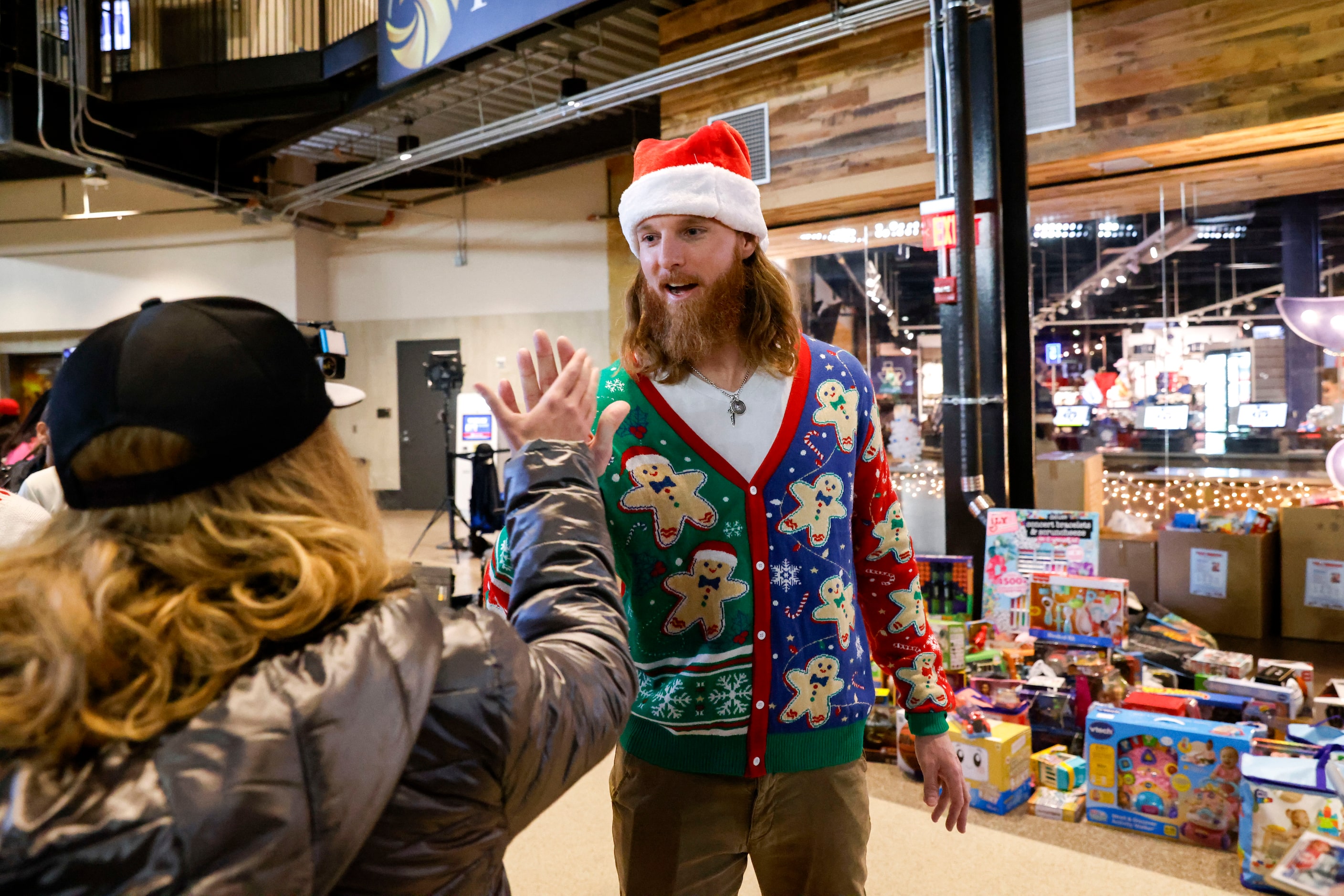 Texas Rangers pitcher Jon Gray high fives a fan during Texas Rangers Toy Drive on,...